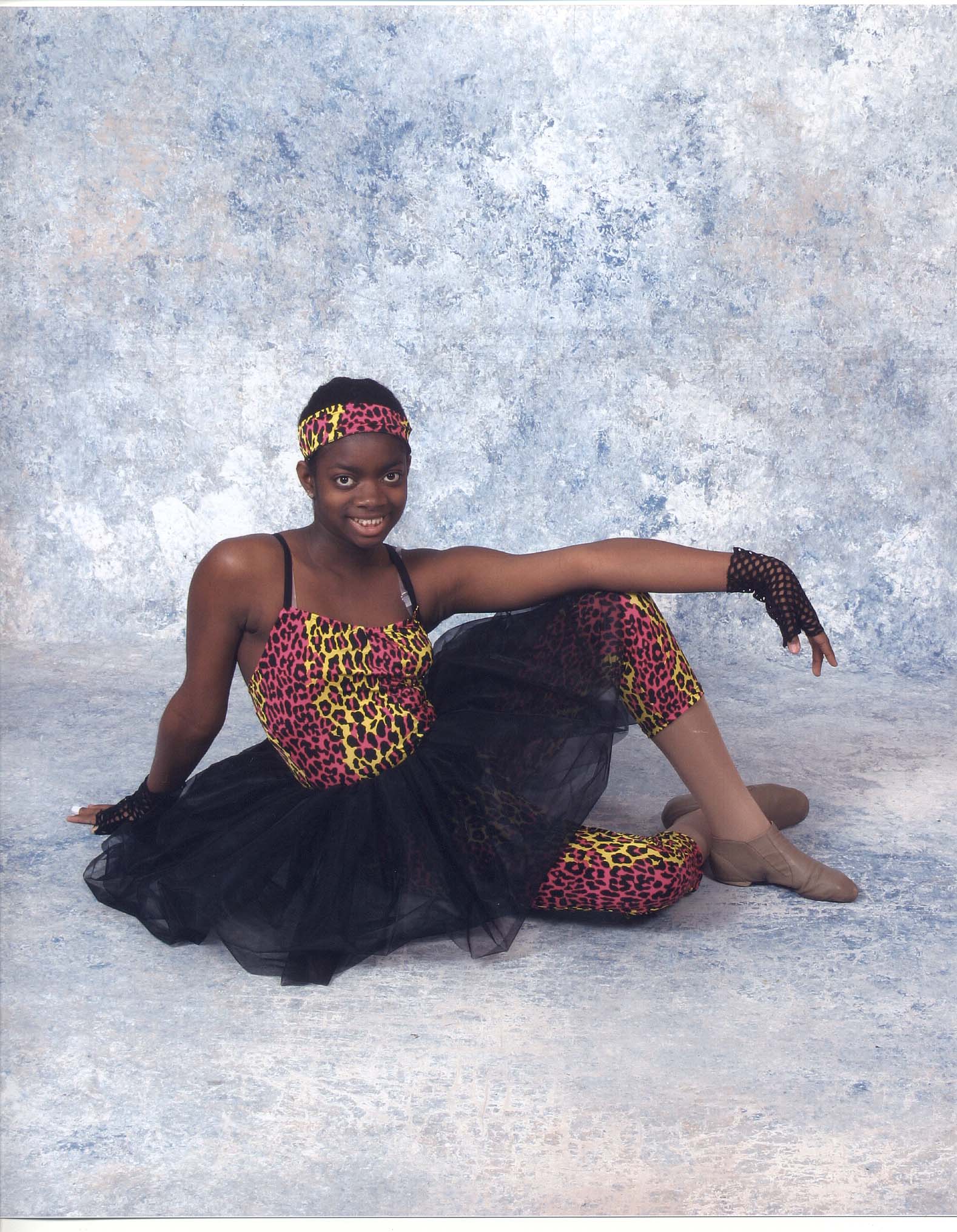 Blessin seated in her jazz costume.
