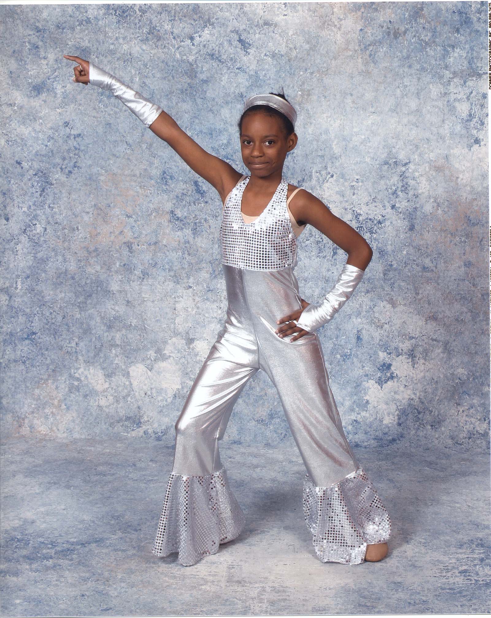 Fortune reaches up in her stunning white jazz costume.