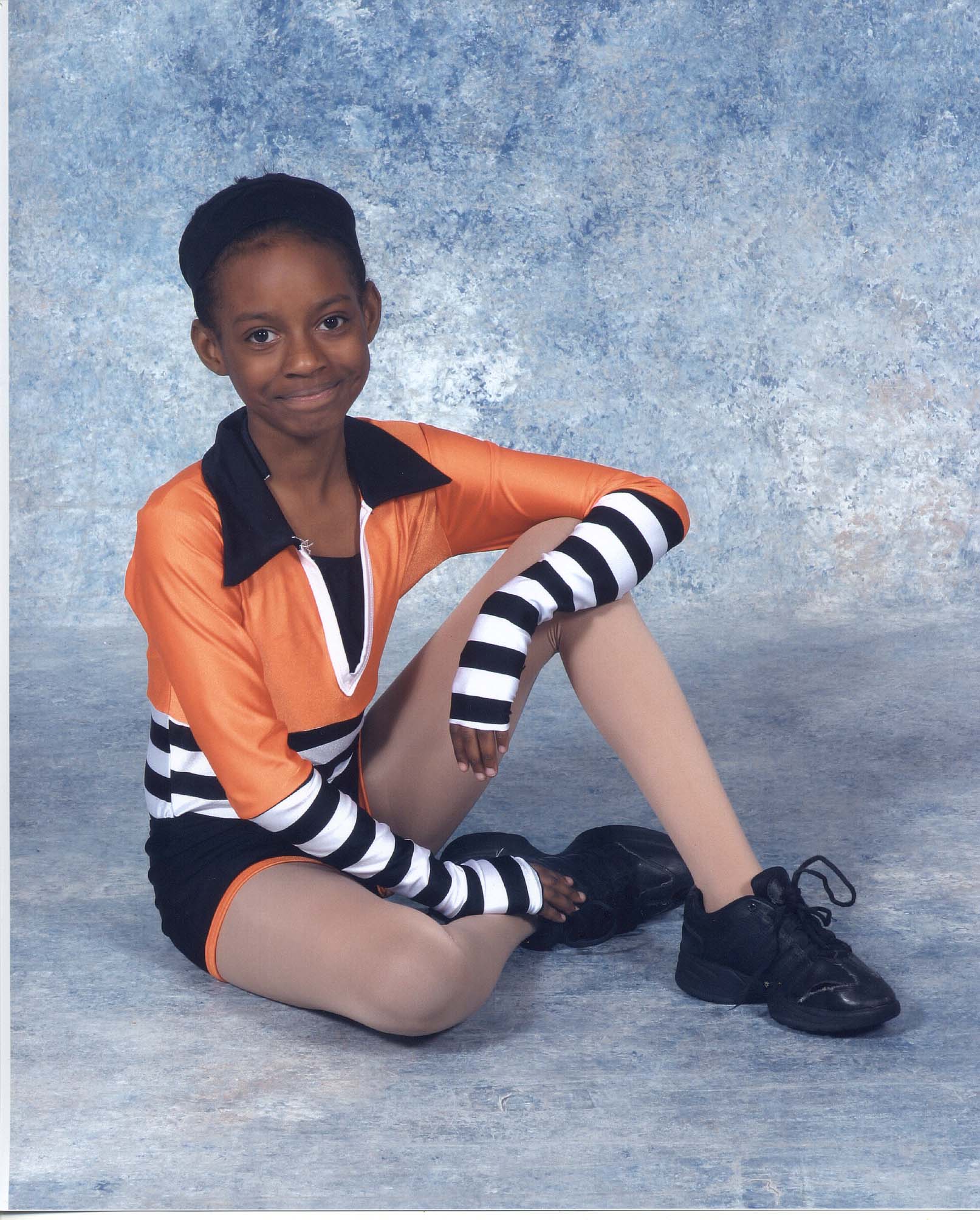 Fortune seated in her acro costume.